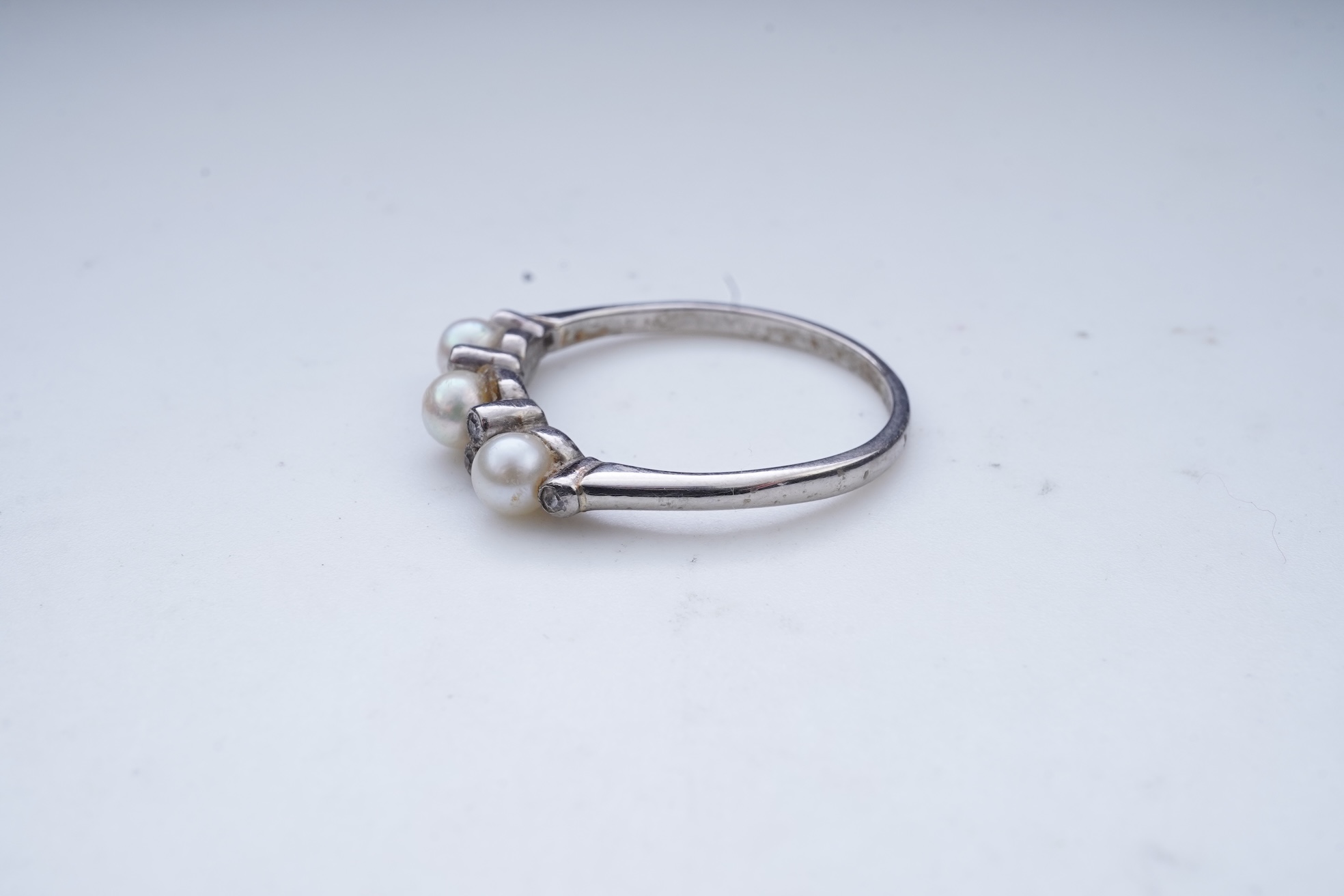 An Edwardian seed pearl brooch and a pearl and diamond ring
